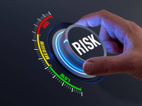 Risk management and mitigation to reduce exposure for financial investment, projects, engineering, businesses. Concept with manager's hand turning knob to low level. Reduction strategy.